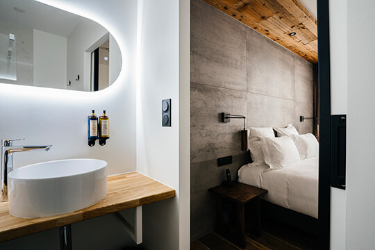 A view of the bathroom and bed area in the standard city-view room